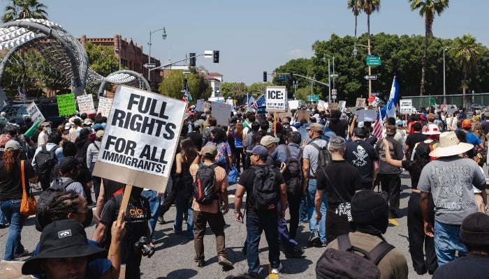 Protesters march through the streets on June 9, 2025 in Downtown Los Angeles, California, USA. — AFP