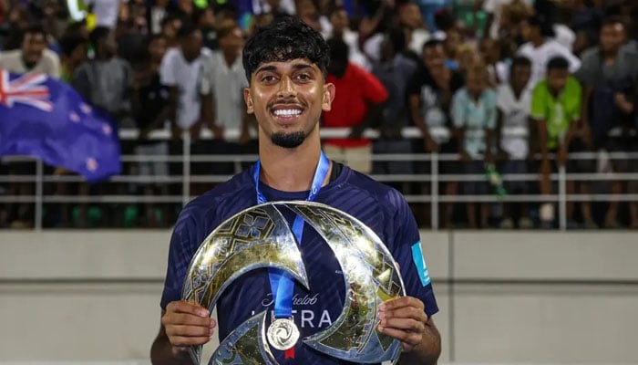 Pakistani origin footballer Haris Zeb poses with a trophy. — Reporter/File