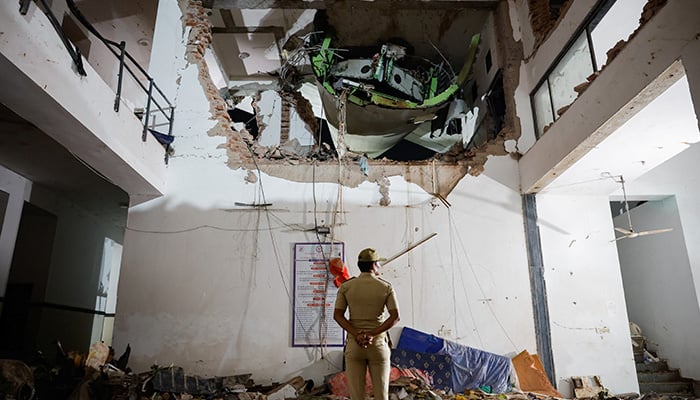 A police officer stands in front of the wreckage of an Air India aircraft, bound for Londons Gatwick Airport, which crashed during take-off from an airport in Ahmedabad, India June 12, 2025. — Reuters