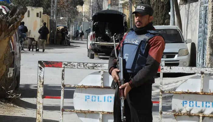 The image shows a police officer holding weapon in his hand. — AFP/File