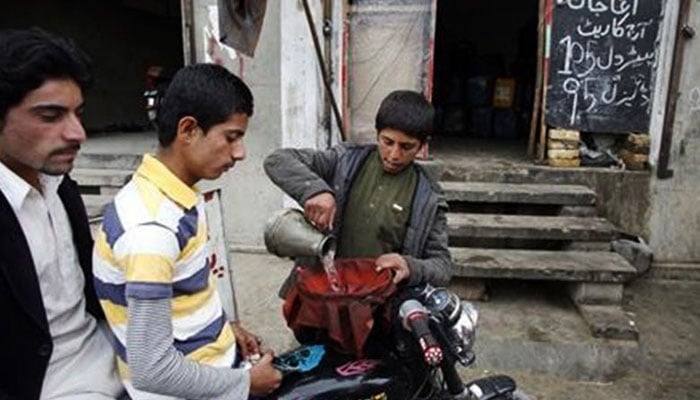 A seller pours petrol smuggled from Iran into a motorcycle in this undated image. — Reuters/File