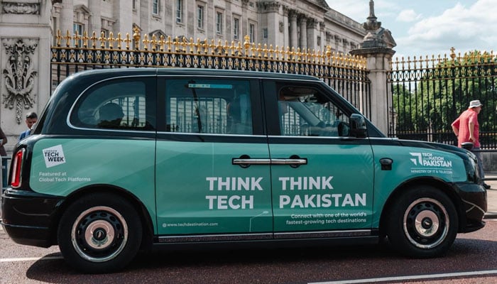 Black taxi parked in London with a message written on it, Think Tech, Think Pakistan. — Reporter