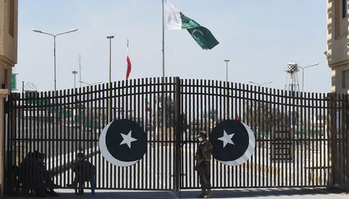 Pakistani soldiers wearing facemasks stand guard at the closed Pakistan-Iran border in Taftan. — AFP/File