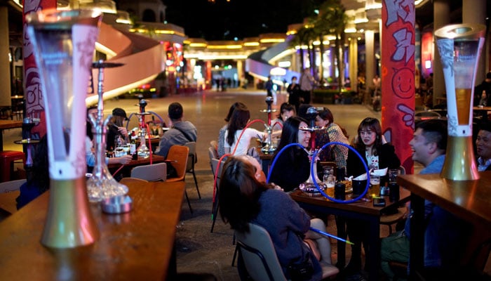 People drink beer at a bar as the coronavirus disease (COVID-19) outbreak continues in Shanghai, China October 15, 2020. — Reuters