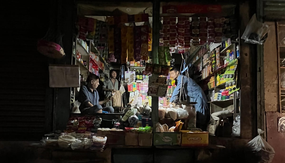 Gullu Bhai and his staff work at the kiryana store during a power outage. — Photo by author