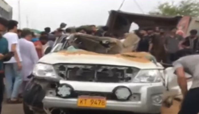 Cranes seen lifting the overturned dumper from the car in Karachi Drigh Road road area on June 19, 2025.— Geo News/screengrab