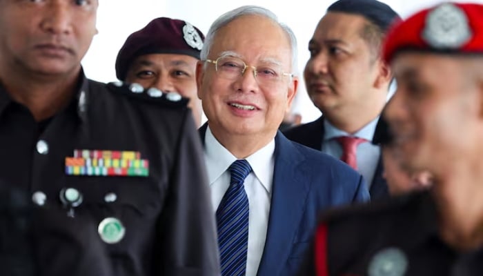 Prison officers escort former Malaysian Prime Minister Najib Razak, as the jailed politician leaves the court during a break in proceedings, in Kuala Lumpur, Malaysia, on April 4, 2024. — Reuters