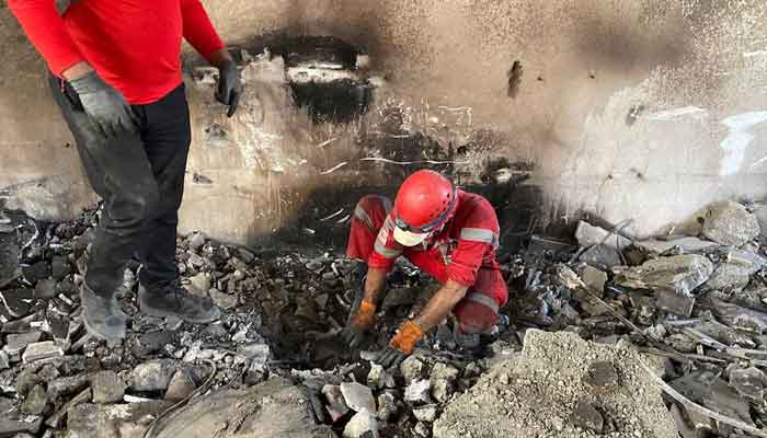 Iranian Red Crescent Society members search through the rubble for victims after Israeli strikes, at an unspecified location in Iran. — Reuters/File