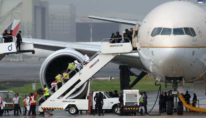 Passengers disembark from a Saudi Arabian Airlines plane parked at the tarmac of Ninoy Aquino International airport in Pasay city, Metro Manila, Philippines September 20, 2016. — Reuters
