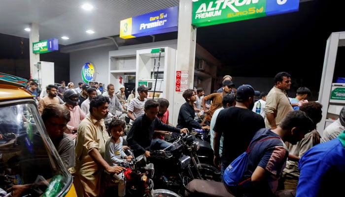 People wait their turn to get fuel at a petrol station, in Karachi, Pakistan June 2, 2022. — Reuters