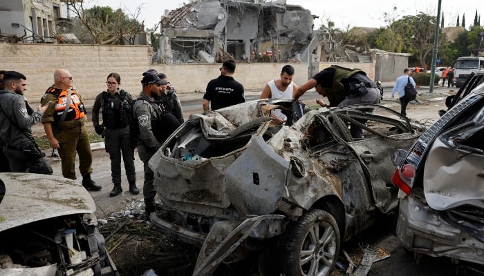 Members of Israeli security forces work at an impact site following Irans strike on Israel, amid the Iran-Israel conflict, in Nes Ziona, Israel, on June 22, 2025. — Reuters