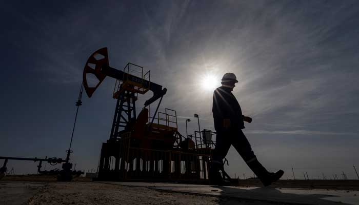 An oil and gas industry worker walks during operations of a drilling rig at Zhetybay field in the Mangystau region, Kazakhstan, November 13, 2023. — Reuters