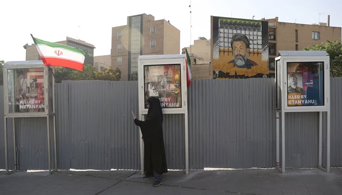 A woman stands on a street, amid the Iran-Israel conflict, in Tehran, Iran, June 23, 2025. — Reuters