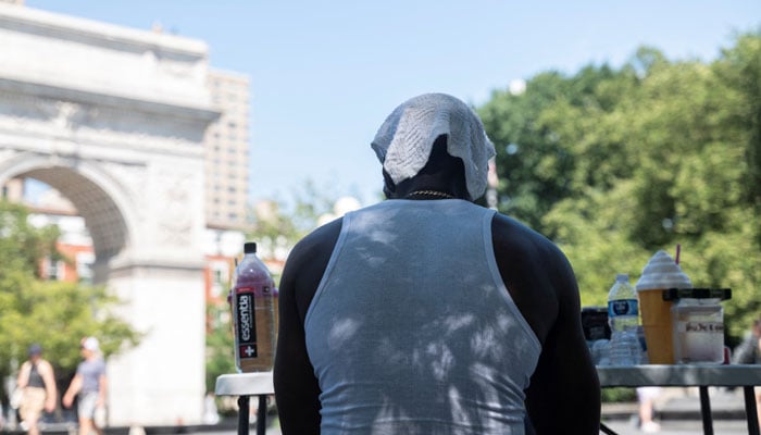 A man covers his head with a towel during a heat wave affecting the US Northeast, in New York City, US, June 24, 2025. — Reuters