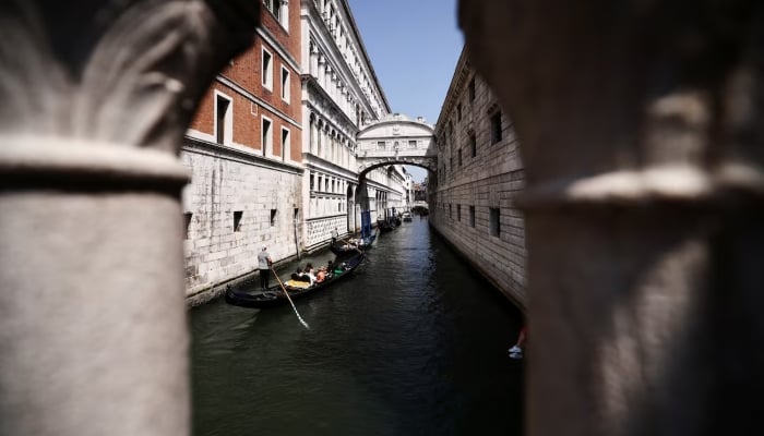 Gondoliers ride their gondolas through the Venice Canal ahead of the expected wedding of Amazon founder Jeff Bezos and Lauren Sanchez, in Venice, Italy, on June 22, 2025. — Reuters