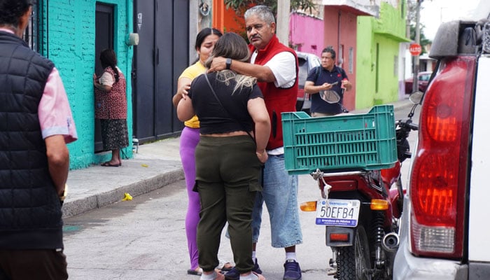 Residents comfort each other after a shooting at the Barrio Nuevo neighbourhood in Irapuato, Guanajuato state, Mexico, on June 25, 2025. — AFP