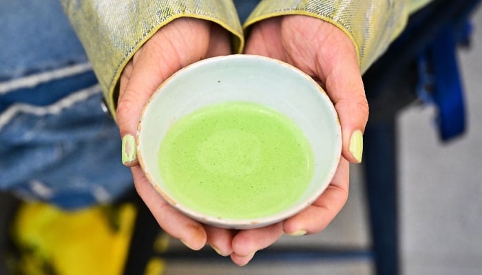 In this picture taken on May 20, 2025, Kate Harwitz displays her matcha beverage at Kettl Tea in the Los Feliz neighbourhood of Los Angeles, California. — AFP