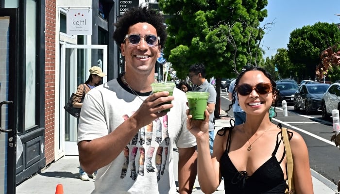 Rohan Cutlip (L) and Alexis Underwood display their iced matcha lattes from Kettl Tea in the Los Feliz neighborhood of Los Angeles, California on May 20, 2025. — AFP