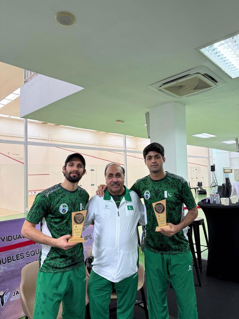 Pakistans Noor Zaman (right) and Nasir Iqbal pose with the trophy. — Reporter