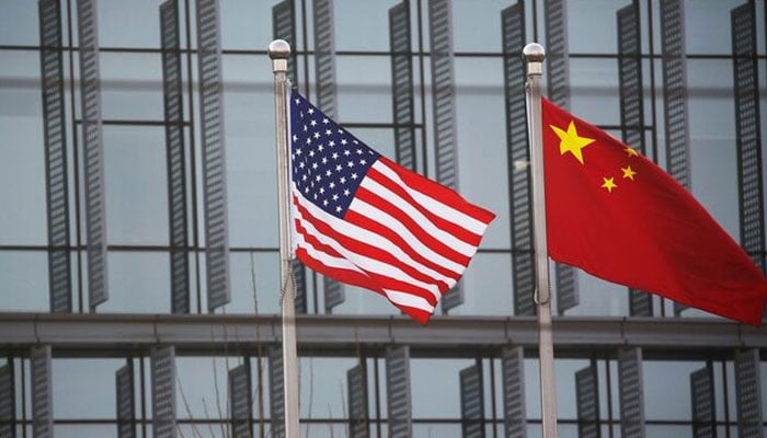Chinese and US flags flutter outside the building of an American company in Beijing, China, January 21, 2021. — Reuters