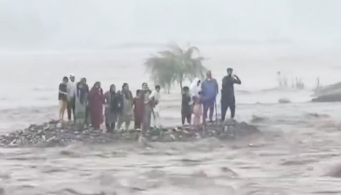 People can be seen stranded in the middle of the Swat River on June 27, 2025, in this still taken from a video. — Instagram/@geonewsdottv