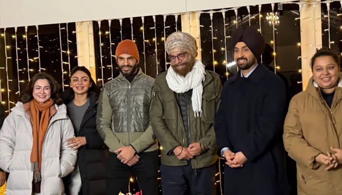 An undated BTS picture from Sardaar Ji 3 shows Hania Aamir, Neeru Bajwa and Diljit Dosanjh with team. — Instagram@pitaaratv