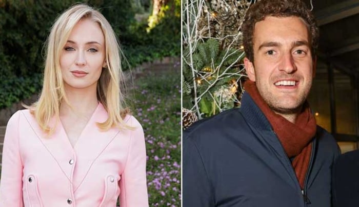 Photo: Sophie Tuner cozies up to beau Peregrine Pearson at Glastonbury