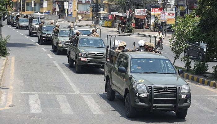 Vehicles of the Pakistan Army and Pakistan Rangers patrolling the Shimla Pahari chowk area during a flag march in Lahore on May 14, 2023. — Online