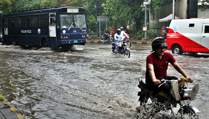 Commuters are facing difficulties in transportation due to stagnant rainwater causing of poor sewerage system after heavy downpour of monsoon season, near American Consulate in Lahore on Friday, June 27, 2025. — PPI