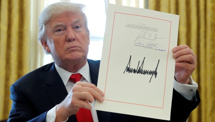 Donald Trump displays his signature after signing the $1.5 trillion tax overhaul plan in the Oval Office of the White House in Washington, US, December 22, 2017. — Reuters