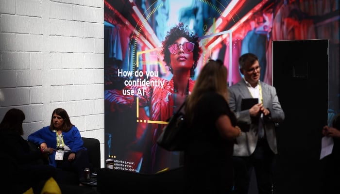 Visitors attend the ninth edition of the AI summit London, in London, on June 11, 2025. — AFP
