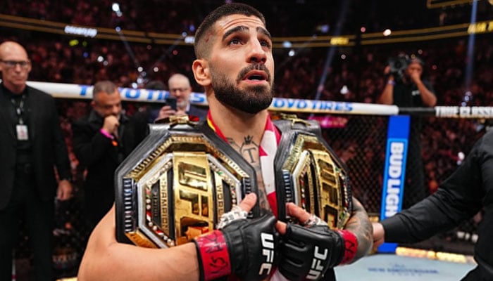 Spains Ilia Topuria poses with his belts after winning his lightweight title match against Charles Oliveira at UFC 317 on June 29, 2025. — X@ufc