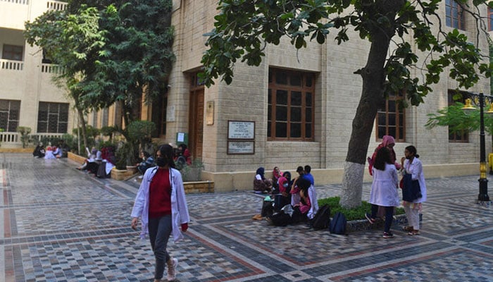Students gather at a yard of the Dow University of Health Sciences in Karachi on January 13, 2022. — AFP