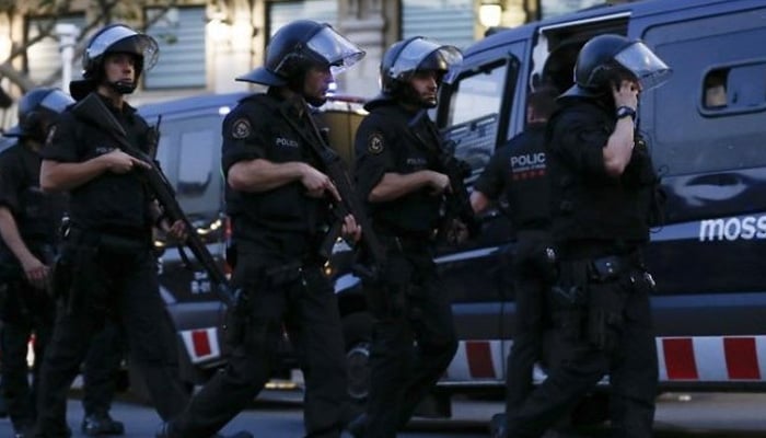Spanish policemen walk in a cordoned off area in Barcelona, Spain. — AFP/File