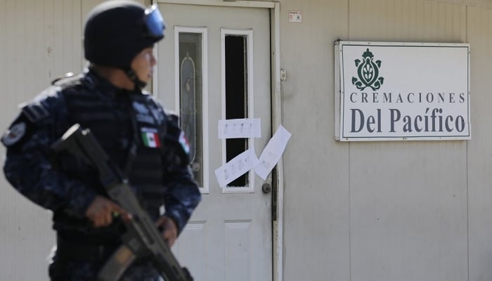 A police officer stands guard outside the sealed-off building housing a crematorium in Llano Largo, on the outskirts of the resort town of Acapulco. — Reuters/File