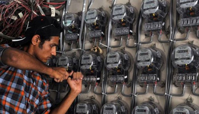 An image showing an electrician working on an electricity meter. — AFP/File