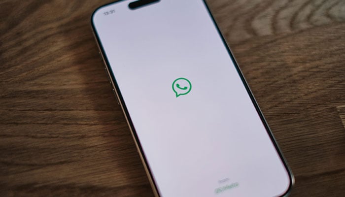 This representational image shows the WhatsApp logo displayed on a phone screen. — Unsplash