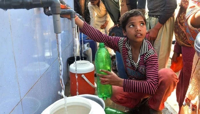 A representational image showing residents filling their cans with drinking water from a filtration plant. — AFP/File