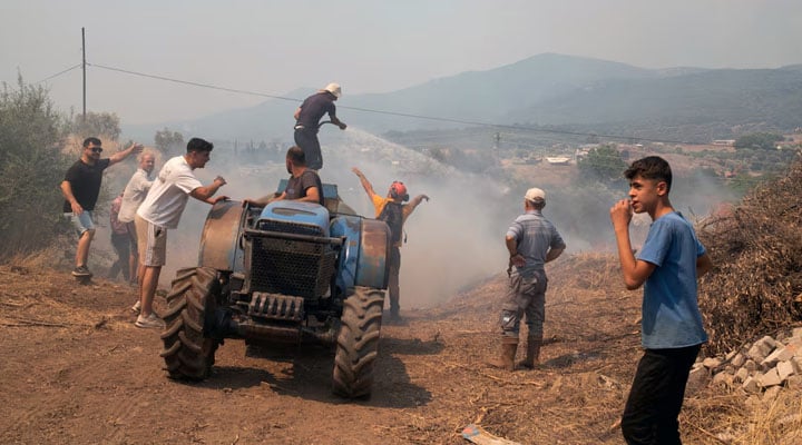 People respond to a wildfire in a village near Seferihisar in Izmir province, Turkey, June 30, 2025. — Reuters