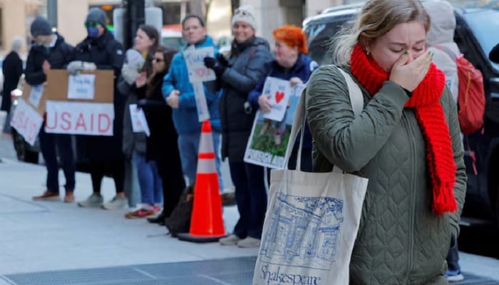 A recently fired USAID staff member reacts while leaving work, during a sendoff by former USAID staffers and supporters outside USAID offices in Washington, DC, US, February 21, 2025. — Reuters