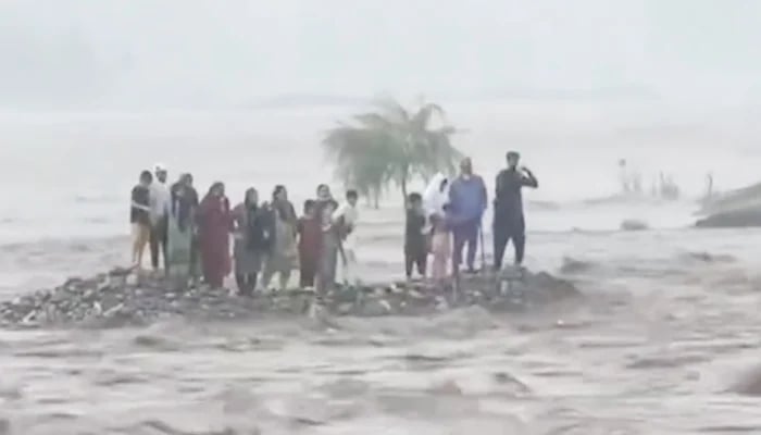 People can be seen stranded in the middle of the Swat River on June 27, 2025, in this still taken from a video. — Instagram/@geonewsdottv