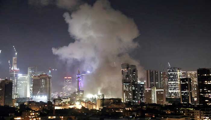 Smoke billows following missile attack from Iran on Israel, at Tel Aviv, Israel. — Reuters