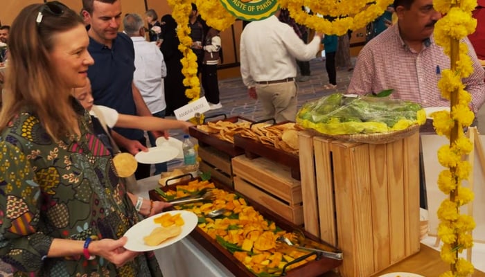 Visitors at the Pakistani Mango Festival are ready to relish eateries from the counter.. — Reporter