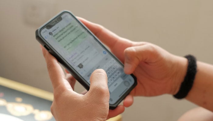 This representational image shows a person texting via WhatsApp. — Unsplash