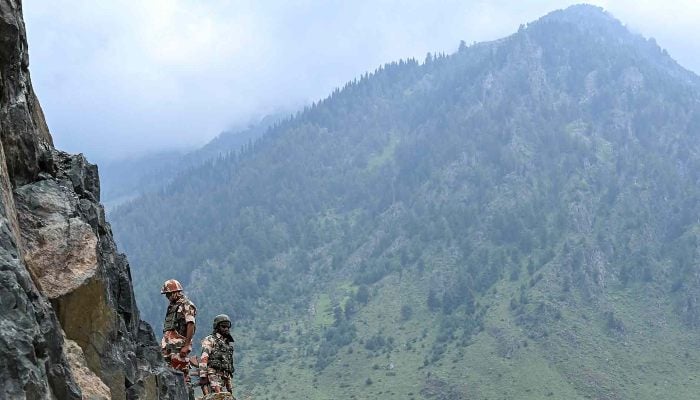 Security personnel stand guard at the top of a mountain ahead of the Hindu pilgrimage, Amarnath, in Chandanwari, IIOJK. — AFP