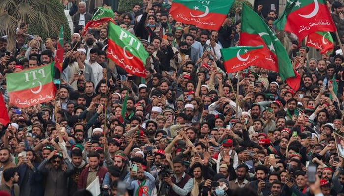 Supporters of PTI wave flags as they hold a protest in Peshawar, on February 17, 2024. — Reuters