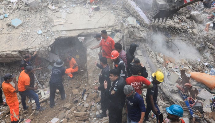 Rescue workers search for survivors as they go through the rubble of a five-storey residential building, which collapsed in Karachi, on July 4, 2025. — Reuters