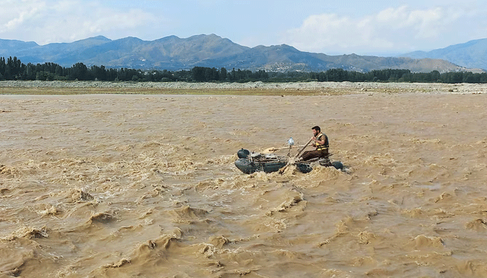 A rescue worker rows a raft while searching for survivors, after tourists, who were on a picnic, were swept away by overflowing floodwaters in the Swat River, in Swat Valley in Pakistan June 27, 2025. — Reuters