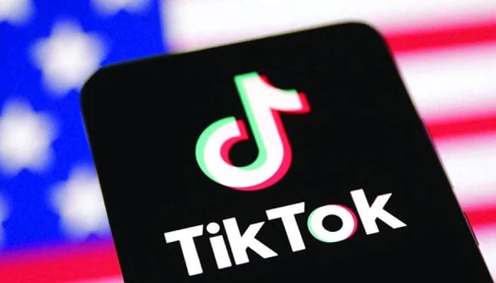 An illustration showing TikTok logo on a mobile screen against the background of a US flag. — Reuters/File