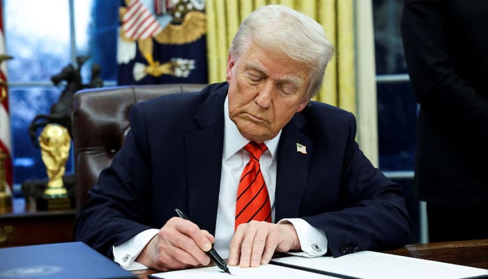 US President Donald Trump signs an executive order in the Oval Office of the White House in Washington, US on February 10, 2025. — Reuters